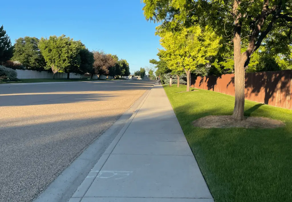 A long sidewalk and green grass.