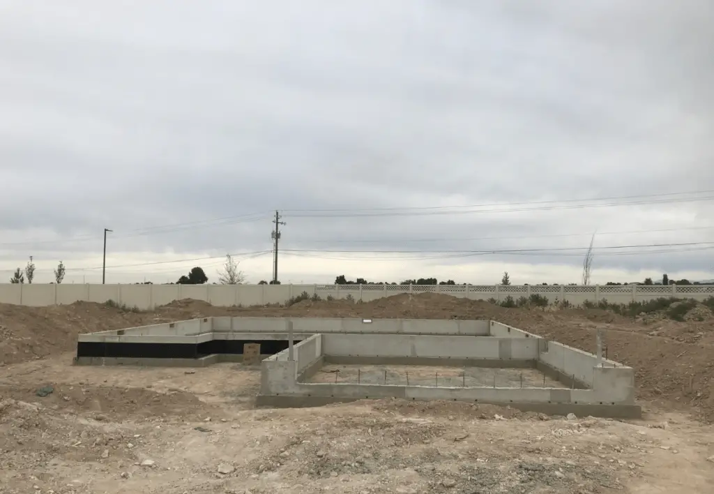 The foundation of a new home an an empty dirt lot in Caldwell, Idaho.